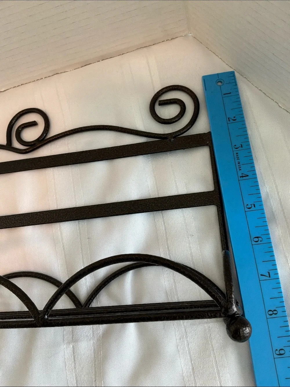 Decorative Brown Metal Wall Rack with Scroll Design